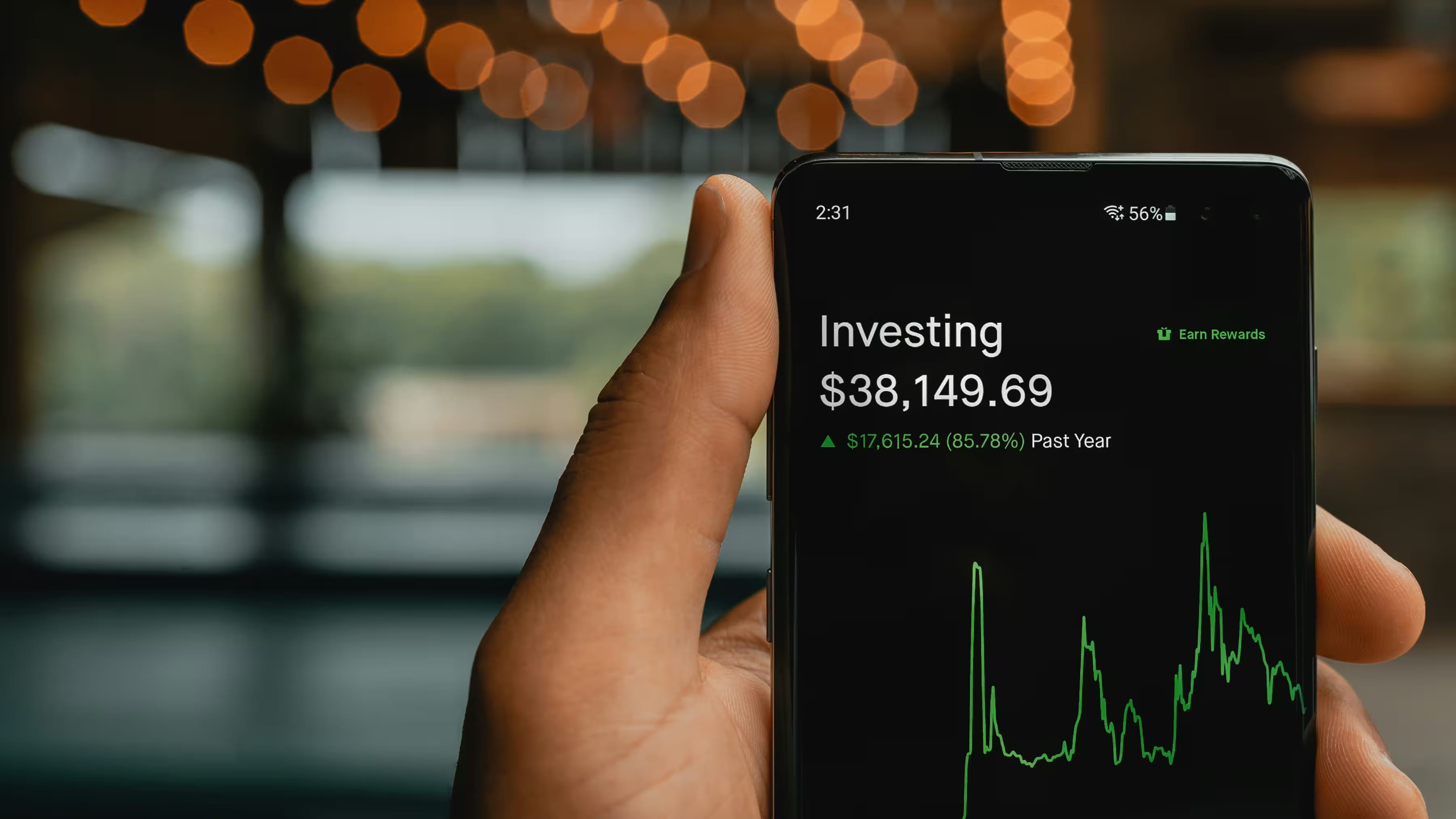 Hand holding a phone, with an investing app open