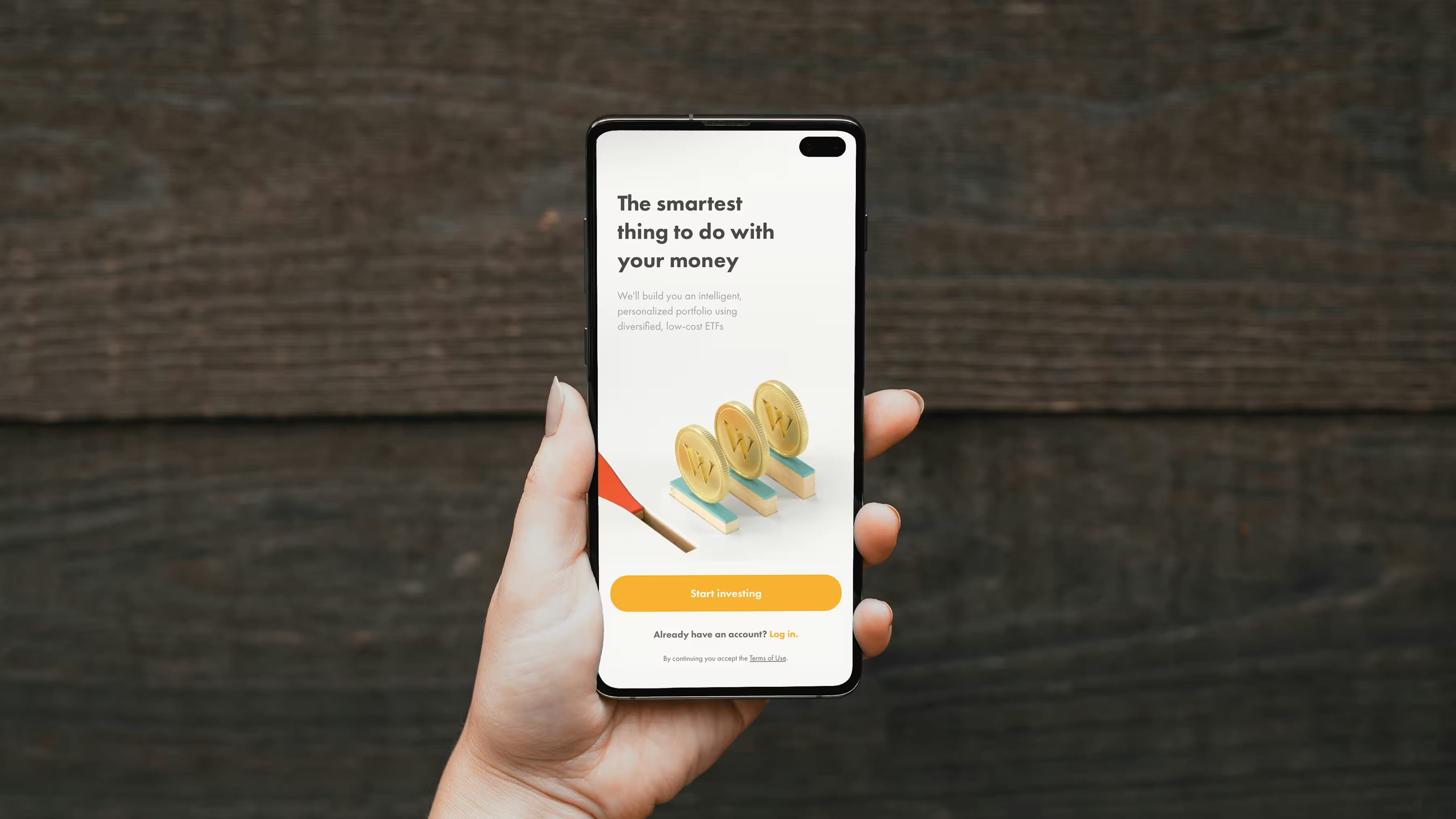 A hand holding a phone, with the Wealthsimple app open