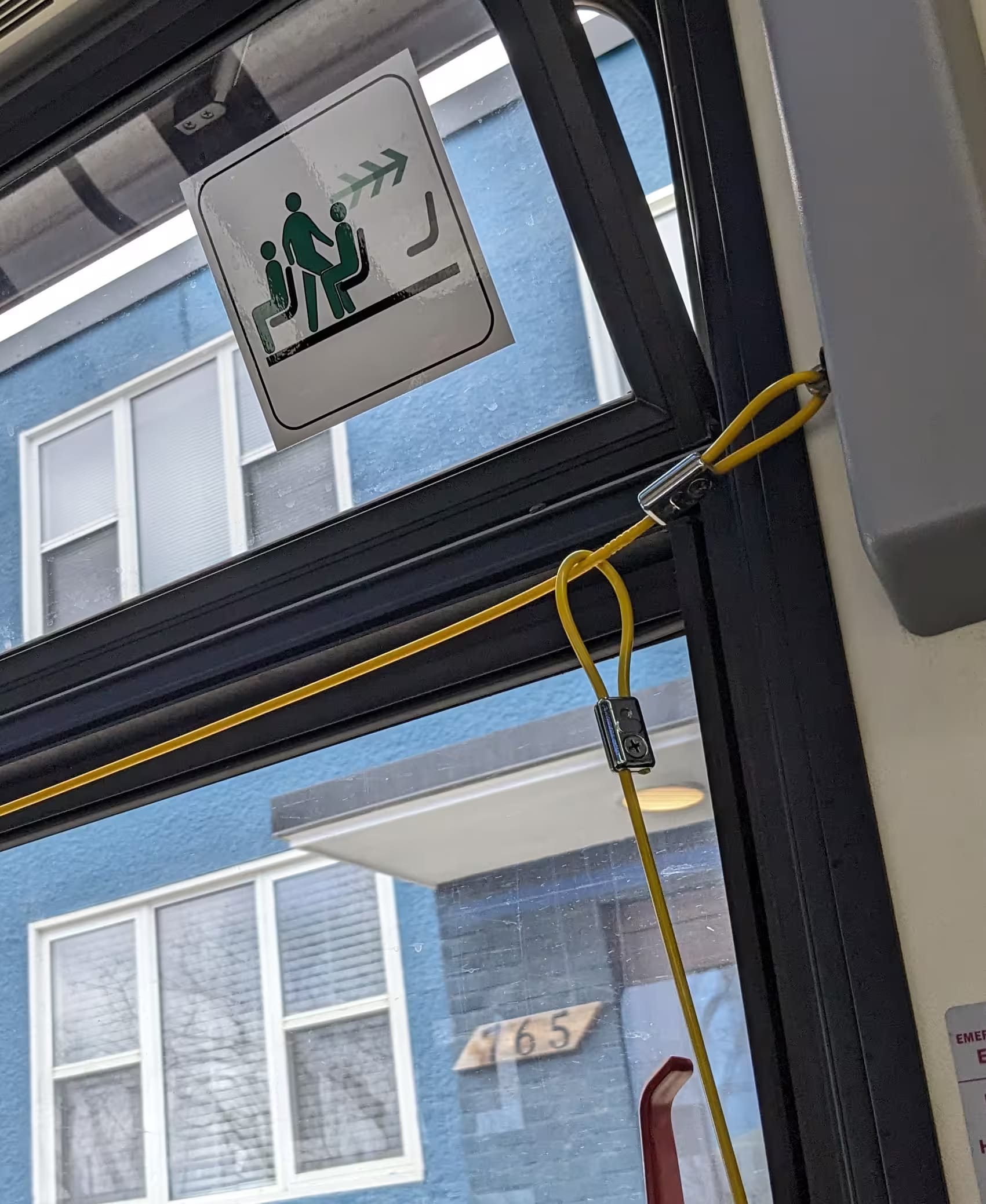 The yellow cord to pull on the bus